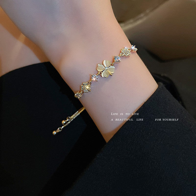 Gold-plated bracelet collection with pearls, cat’s eye stones, and floral motifs
