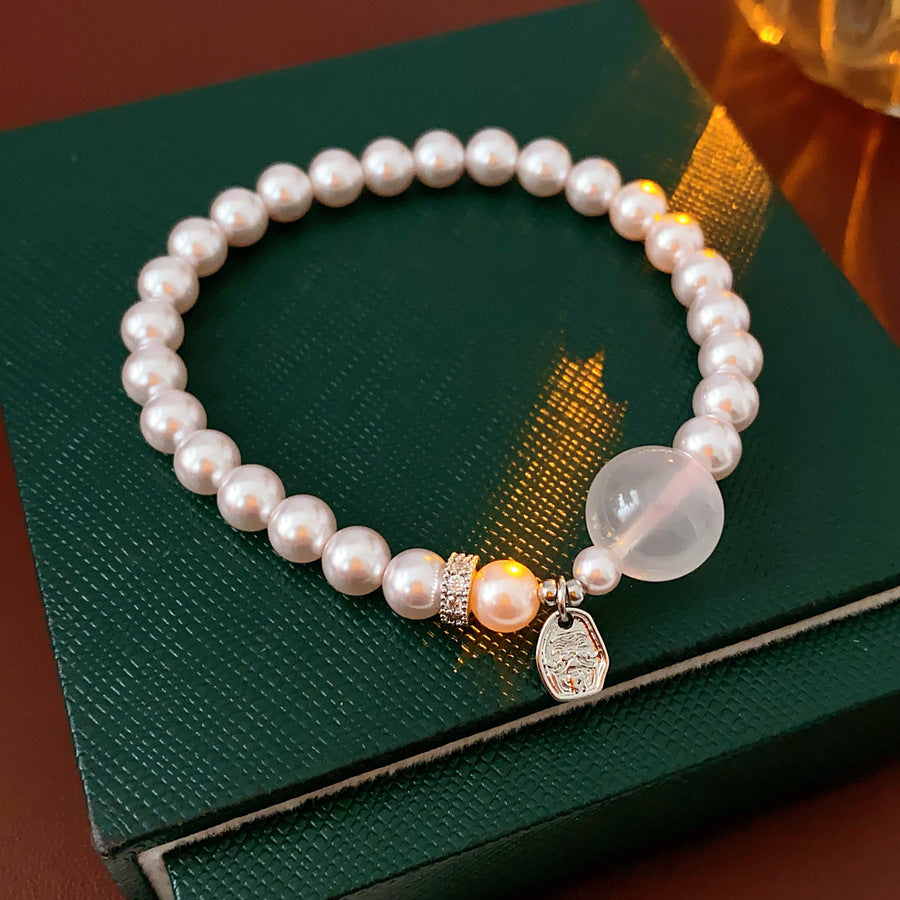 Shijia pearl beaded bracelet with crystal orb focal, zircon spacer and silver-tone coin charm — Moonlit Pearl Charm Bracelet.