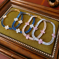 Petal Sparkle Tennis Bracelet lineup in gold and silver with pink and blue accents – baguette zircon floral design