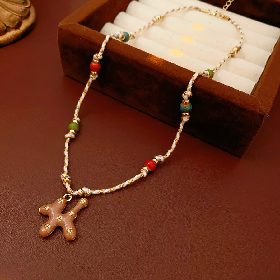 Boho ceramic charm rope necklace with multicolor beads and tan enamel pendant on cotton cord