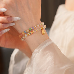 Double-layer dopamine crystal bracelet with clear crystals and colorful stone beads on green velvet background