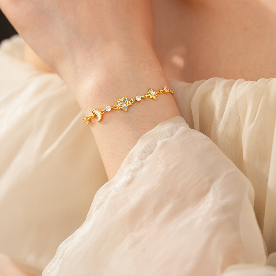 Lunar Starlight Charm Bracelet with crescent moon and star motifs on gold-tone chain – Glazenya