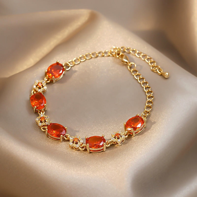Gold-plated bracelet with emerald crystal centerpiece and zircon accents