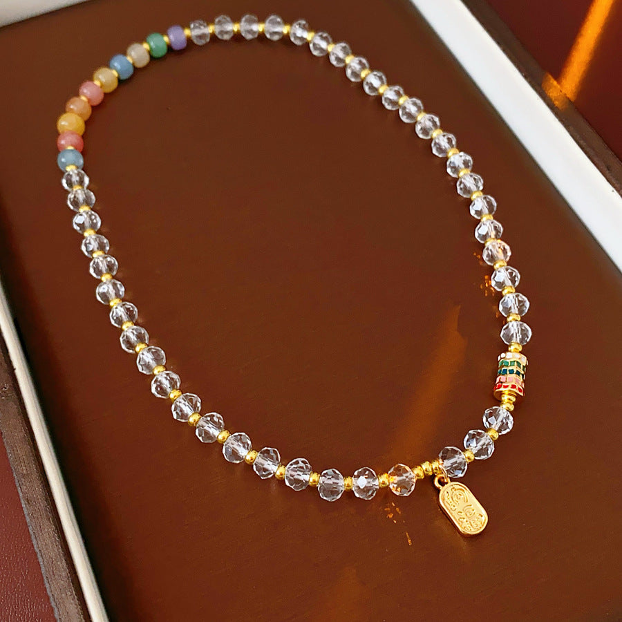 Double-layer dopamine crystal bracelet with clear crystals and colorful stone beads on green velvet background