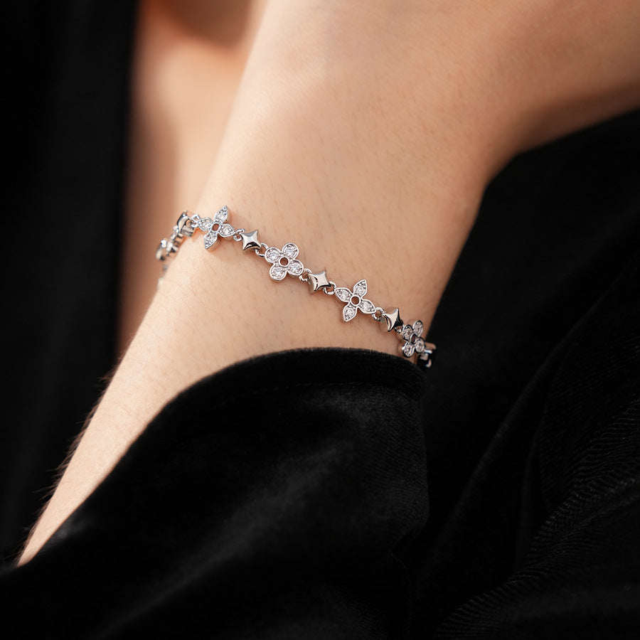 Radiant Flora Bracelet with zircon-studded floral and star motifs on dark blue box – Glazenya jewelry