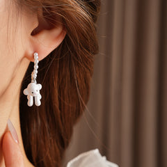 Pearl-adorned hoop earrings with dangling puppy charms in white and coffee — Pearl Pup Charm Hoops.