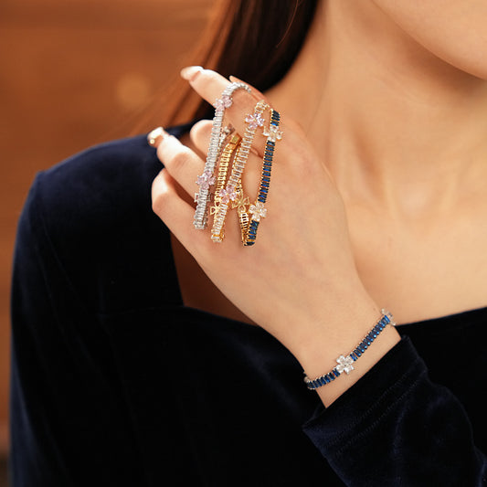 Petal Sparkle Tennis Bracelet lineup in gold and silver with pink and blue accents – baguette zircon floral design