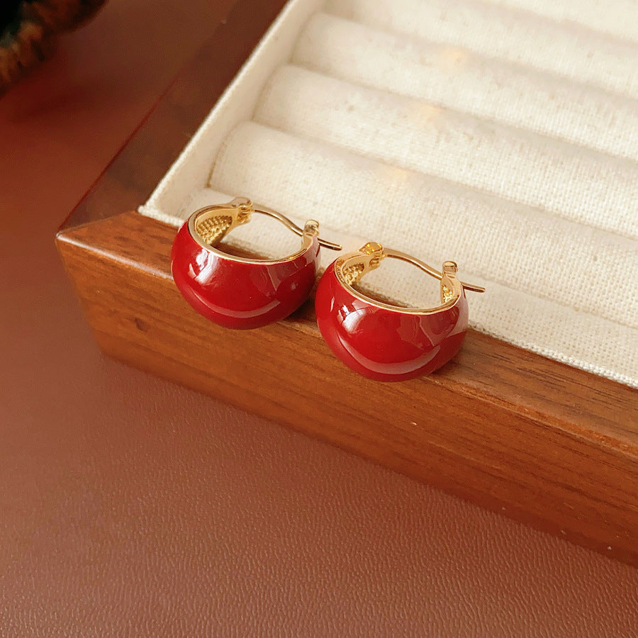 Cherry-red enamel dome huggie hoop earrings with gold tone finish — Cherry Lacquer Dome Huggies.