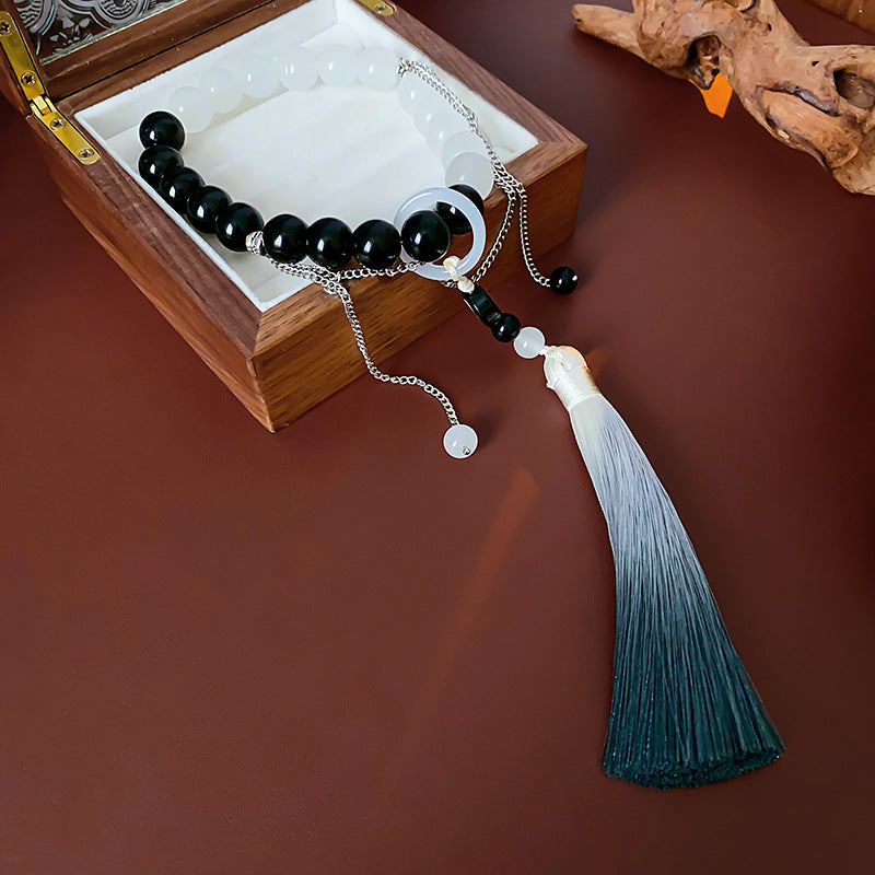 Black and white colored-glass beaded bracelet with yin-yang charm and gradient tassel — Yin-Yang Serenity Tassel Bracelet by Glazenya.