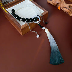 Black and white colored-glass beaded bracelet with yin-yang charm and gradient tassel — Yin-Yang Serenity Tassel Bracelet by Glazenya.