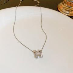 H initial jewelry series — necklace, ring, and earrings displayed individually