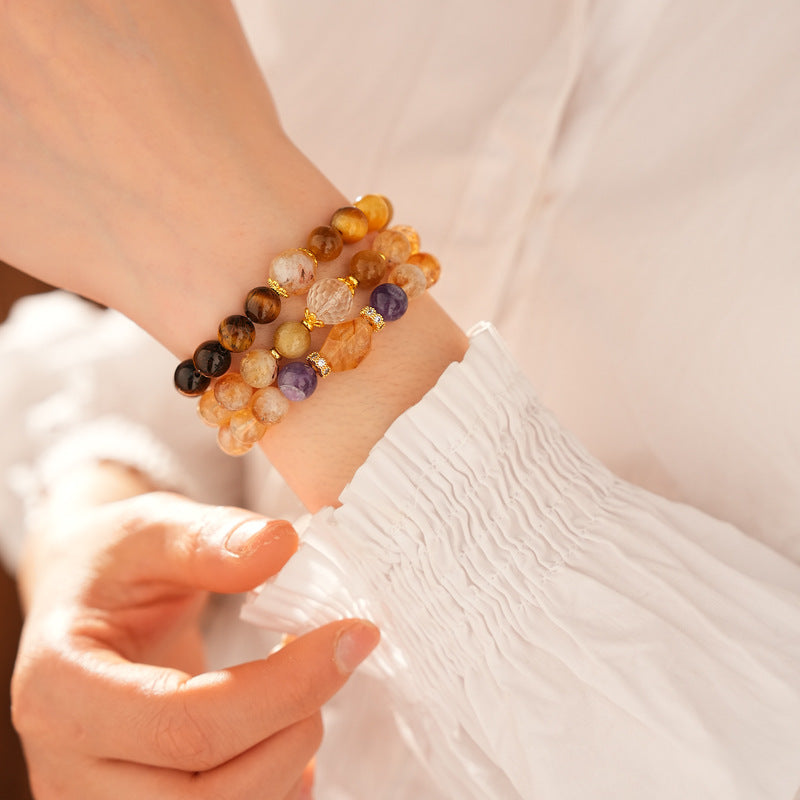 Sunset Harmony Crystal Bangle with yellow crystal and tiger-eye beads, gold-tone spacers, and a clear ring core.