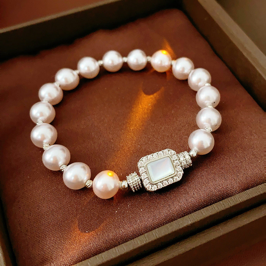 Deco Halo Pearl Bracelet featuring luminous pearls and a pavé-framed rectangular mother-of-pearl charm.