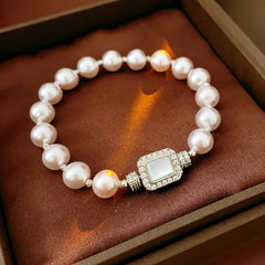 Deco Halo Pearl Bracelet featuring luminous pearls and a pavé-framed rectangular mother-of-pearl charm.