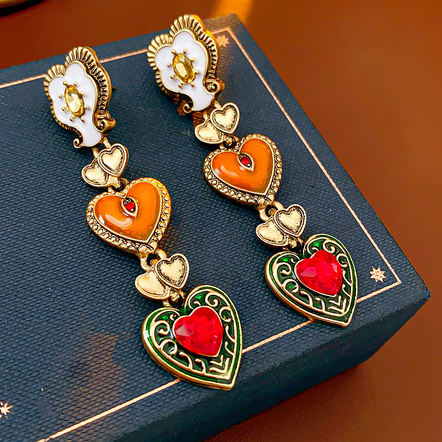 Enchanted Love Drop Earrings – vintage baroque heart-shaped dangle design with gold alloy and red crystal accents, 7cm length jewelry display