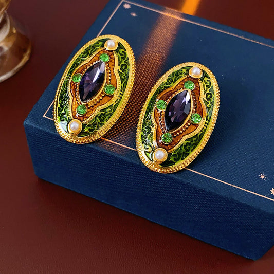 Antique-gold oval earrings with marquise purple crystal, olive rhinestones, and pearl accents — Byzantine Marquise Pearl Oval Earrings.
