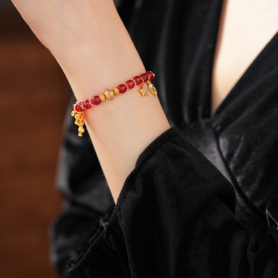 Aurora Red Prosperity Bracelet with red crystal beads and golden fortune charms—star, coin, and drum—on adjustable chain – Glazenya