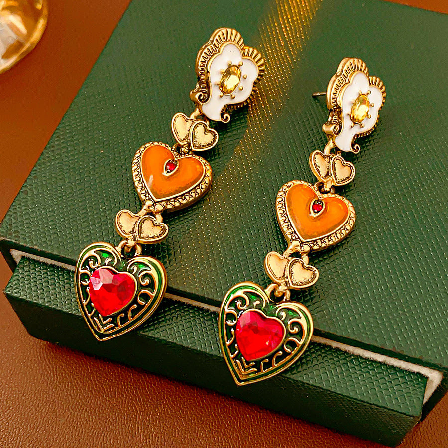 Enchanted Love Drop Earrings – vintage baroque heart-shaped dangle design with gold alloy and red crystal accents, 7cm length jewelry display