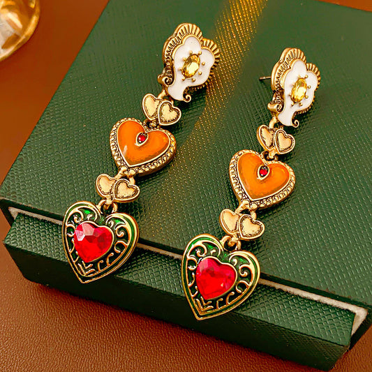 Enchanted Love Drop Earrings – vintage baroque heart-shaped dangle design with gold alloy and red crystal accents, 7cm length jewelry display