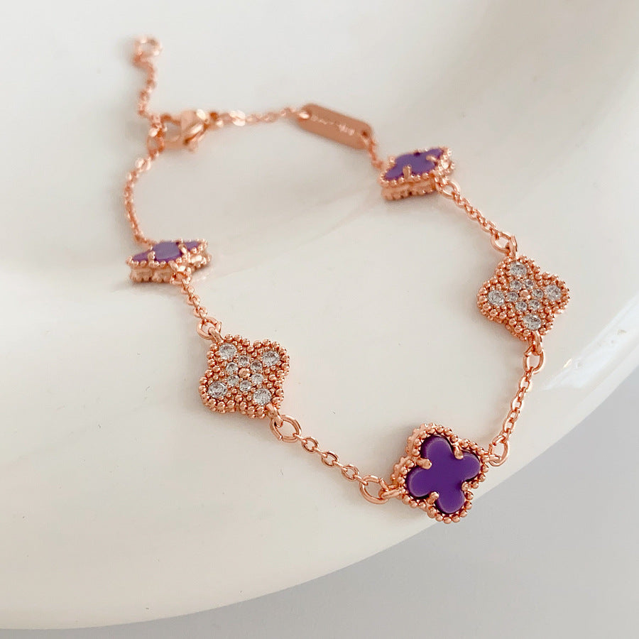 Detailed view of violet enamel clover and rhinestone motifs on Glazenya bracelet