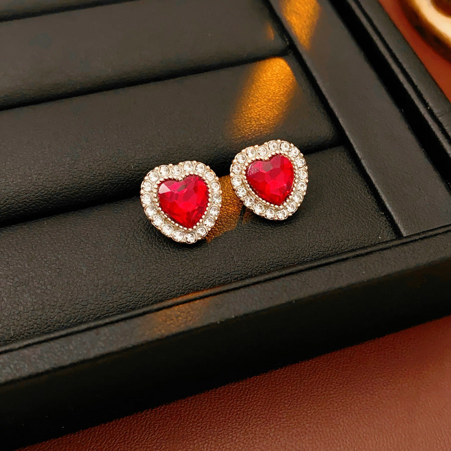 Crimson Heart Luxe Collection with red heart gemstone necklace, bracelet, and earrings, accented with pavé details