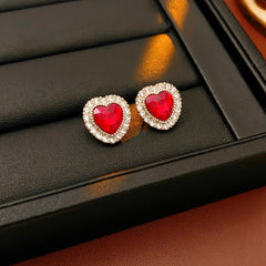 Crimson Heart Luxe Collection with red heart gemstone necklace, bracelet, and earrings, accented with pavé details