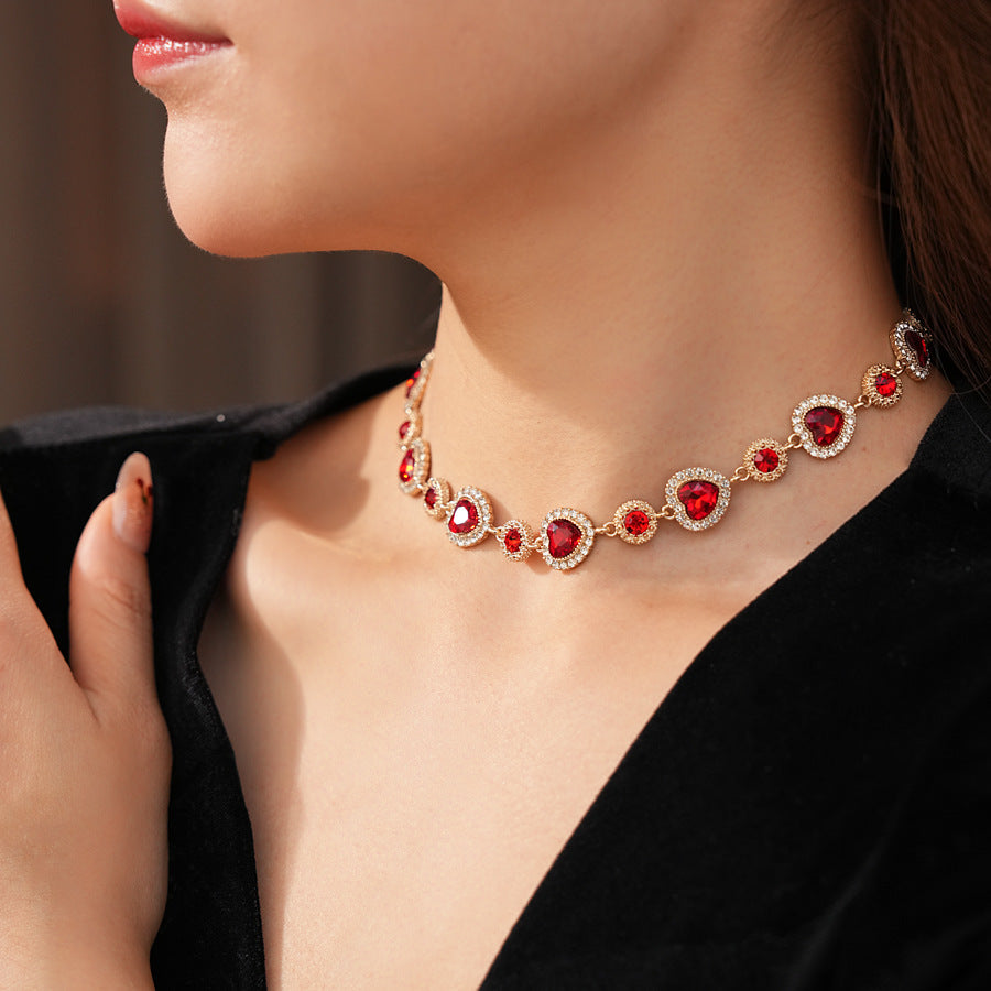 Crimson Heart Luxe Collection with red heart gemstone necklace, bracelet, and earrings, accented with pavé details