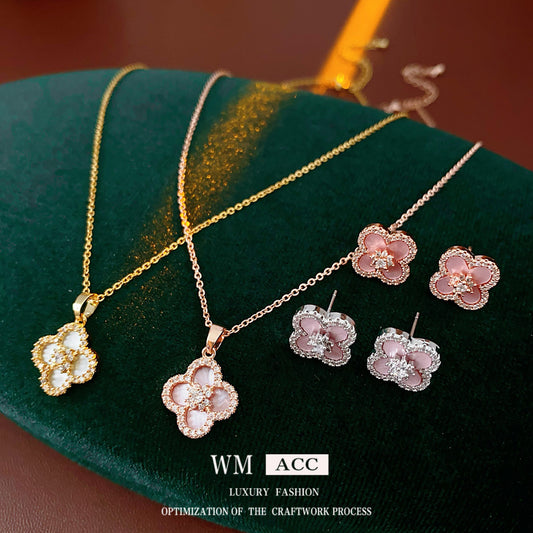 Clover jewelry collection — earrings and necklace displayed together