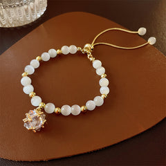 Gold-plated bracelet collection with pearls, cat’s eye stones, and floral motifs