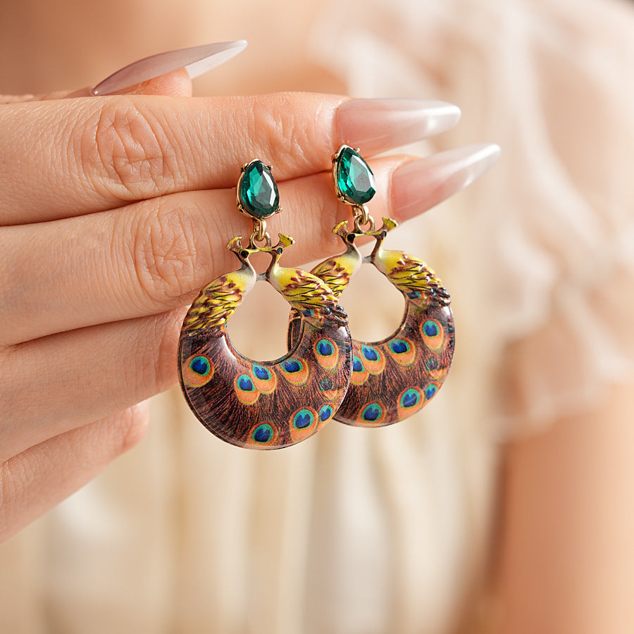 Statement earrings with peacock feather hoop design and emerald stud – Peacock Glory Statement Earrings.