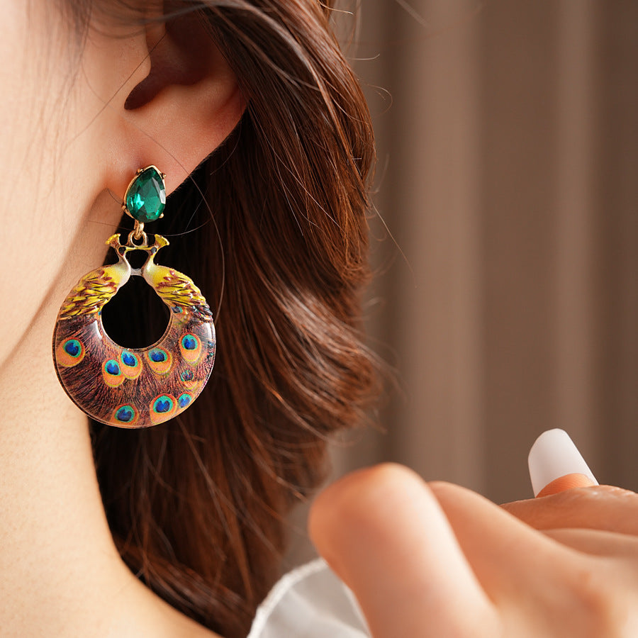 Statement earrings with peacock feather hoop design and emerald stud – Peacock Glory Statement Earrings.