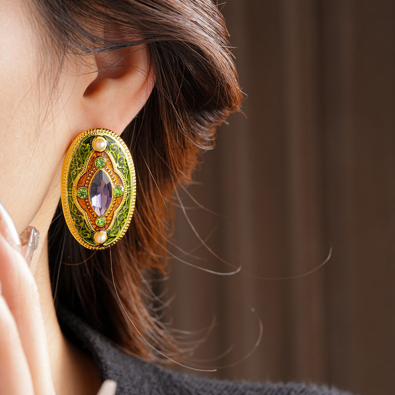 Antique-gold oval earrings with marquise purple crystal, olive rhinestones, and pearl accents — Byzantine Marquise Pearl Oval Earrings.