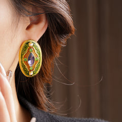 Antique-gold oval earrings with marquise purple crystal, olive rhinestones, and pearl accents — Byzantine Marquise Pearl Oval Earrings.