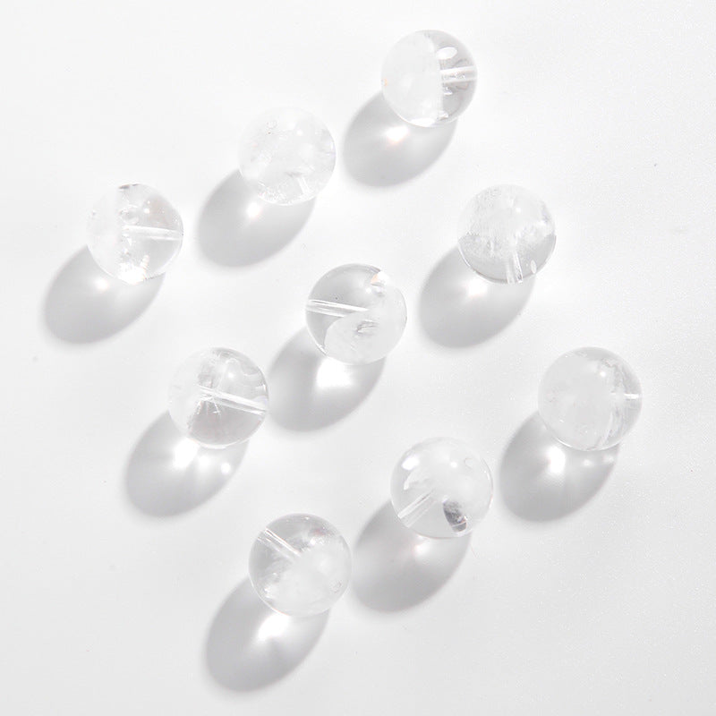 Clear quartz crystal rounds with white phantom inclusions and faint rainbow flash — Frostbow Atrium (7–14 mm).