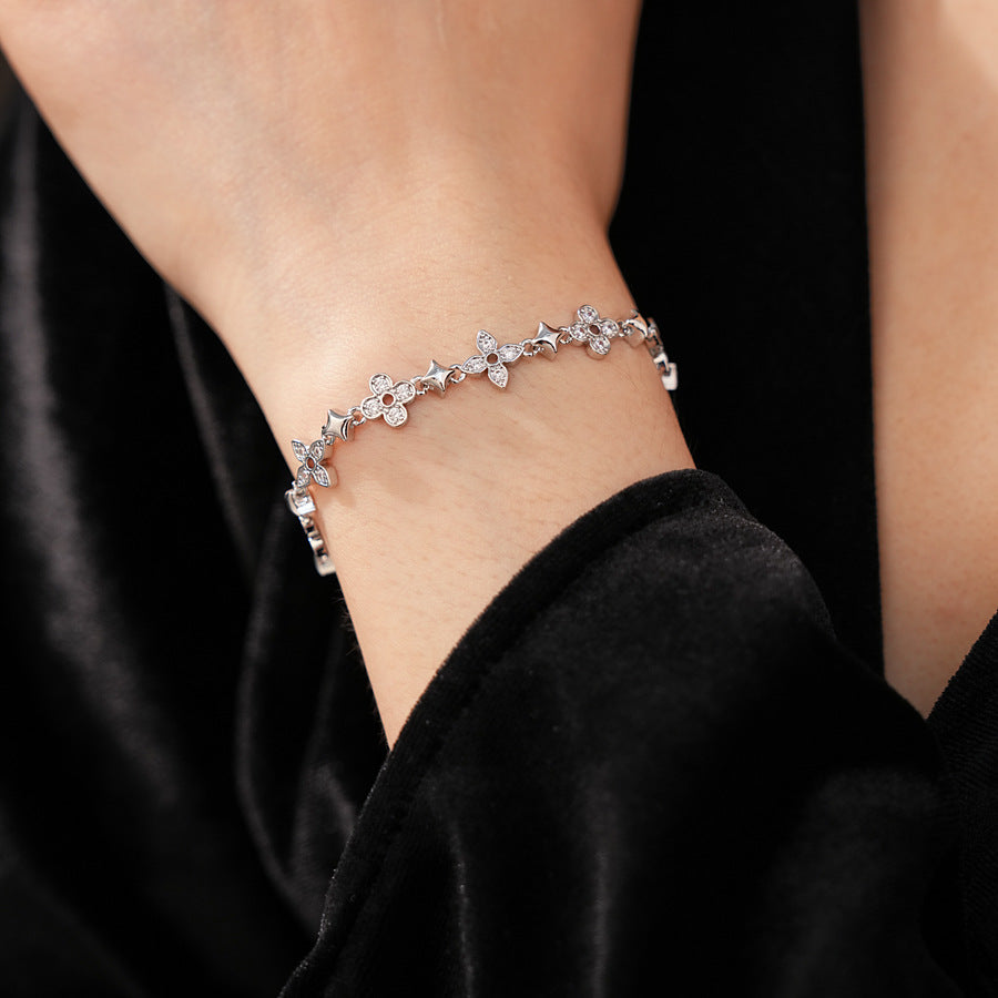 Radiant Flora Bracelet with zircon-studded floral and star motifs on dark blue box – Glazenya jewelry