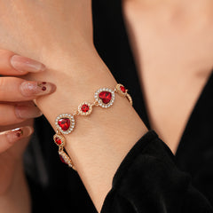 Crimson Heart Luxe Collection with red heart gemstone necklace, bracelet, and earrings, accented with pavé details