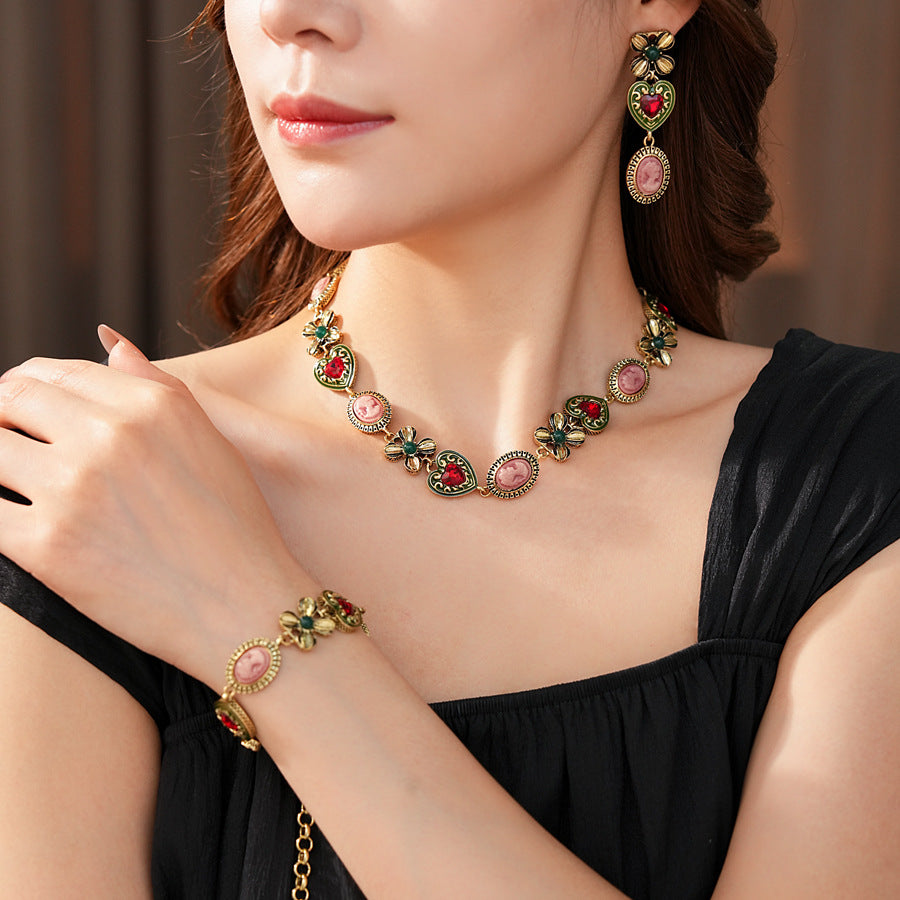 Royal Garden Cameo Set with gold-tone floral links, pink cameo ovals, green enamel hearts, and red stones