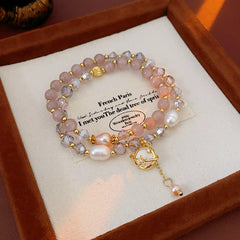 Celestial Cat’s Eye Bracelet double strand with cat’s-eye stones, freshwater pearls, crystal beads and gold planet charm