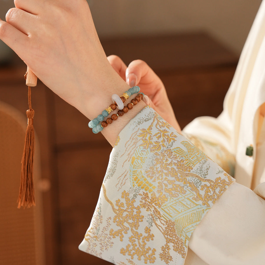 A double-wrap bracelet of sea blue and brown chalcedony beads, embellished with white rings - Dual-Tone Chalcedony Double-Wrap Bracelet.