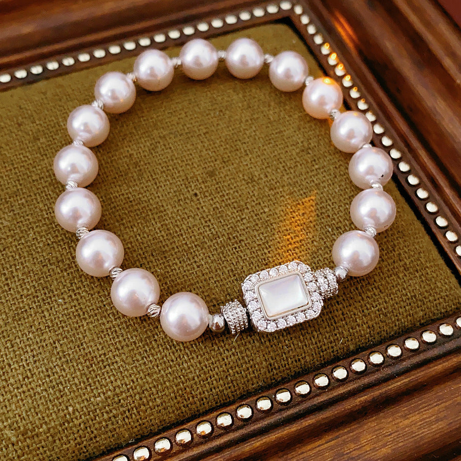 Deco Halo Pearl Bracelet featuring luminous pearls and a pavé-framed rectangular mother-of-pearl charm.