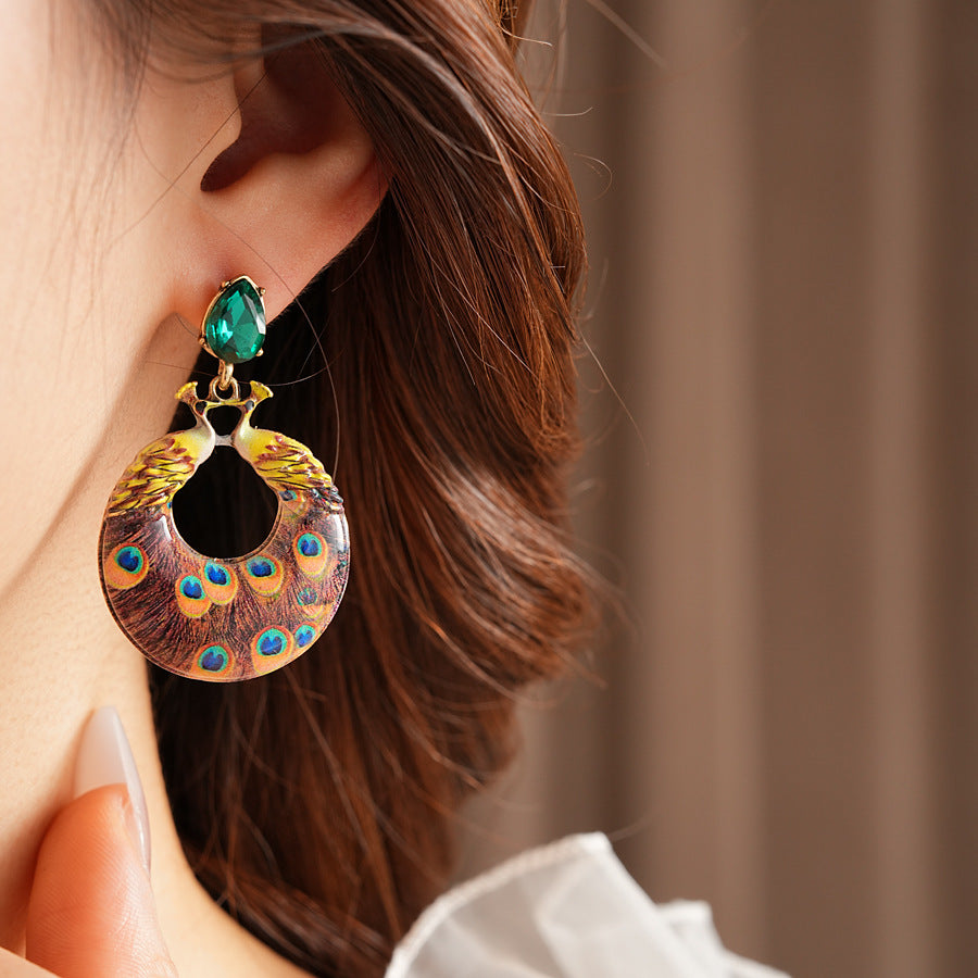 Statement earrings with peacock feather hoop design and emerald stud – Peacock Glory Statement Earrings.