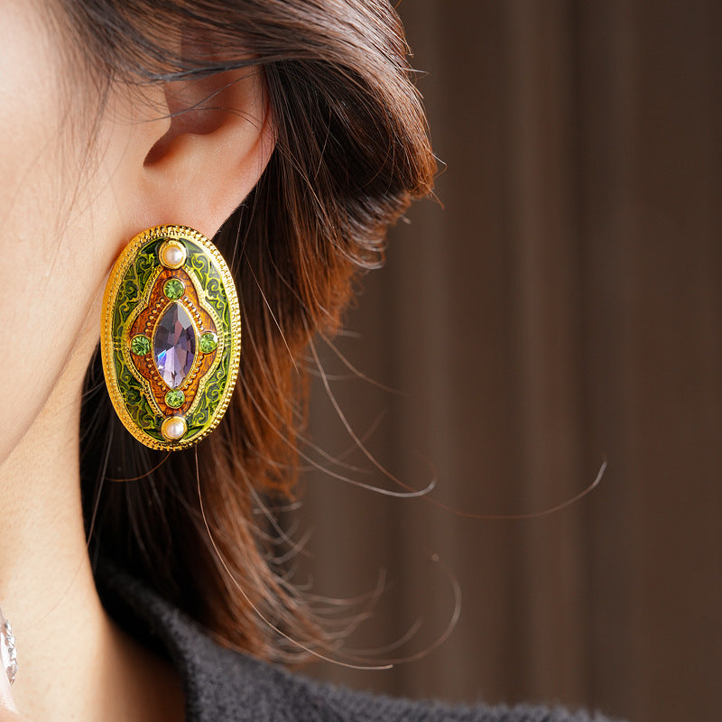 Antique-gold oval earrings with marquise purple crystal, olive rhinestones, and pearl accents — Byzantine Marquise Pearl Oval Earrings.
