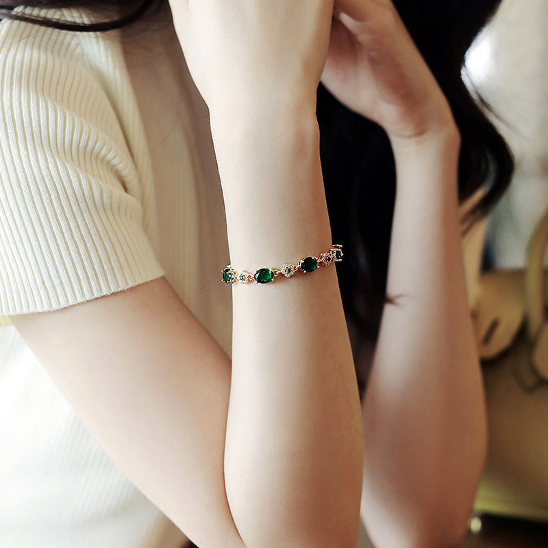 Gold-plated bracelet with emerald crystal centerpiece and zircon accents