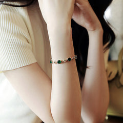 Gold-plated bracelet with emerald crystal centerpiece and zircon accents