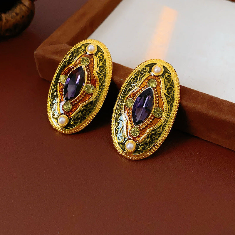 Antique-gold oval earrings with marquise purple crystal, olive rhinestones, and pearl accents — Byzantine Marquise Pearl Oval Earrings.