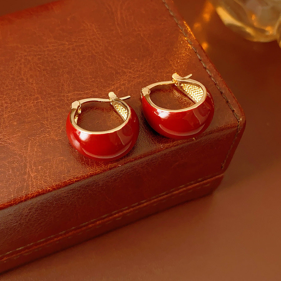 Cherry-red enamel dome huggie hoop earrings with gold tone finish — Cherry Lacquer Dome Huggies.