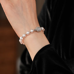 Deco Halo Pearl Bracelet featuring luminous pearls and a pavé-framed rectangular mother-of-pearl charm.