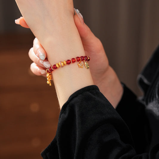 Aurora Red Prosperity Bracelet with red crystal beads and golden fortune charms—star, coin, and drum—on adjustable chain – Glazenya