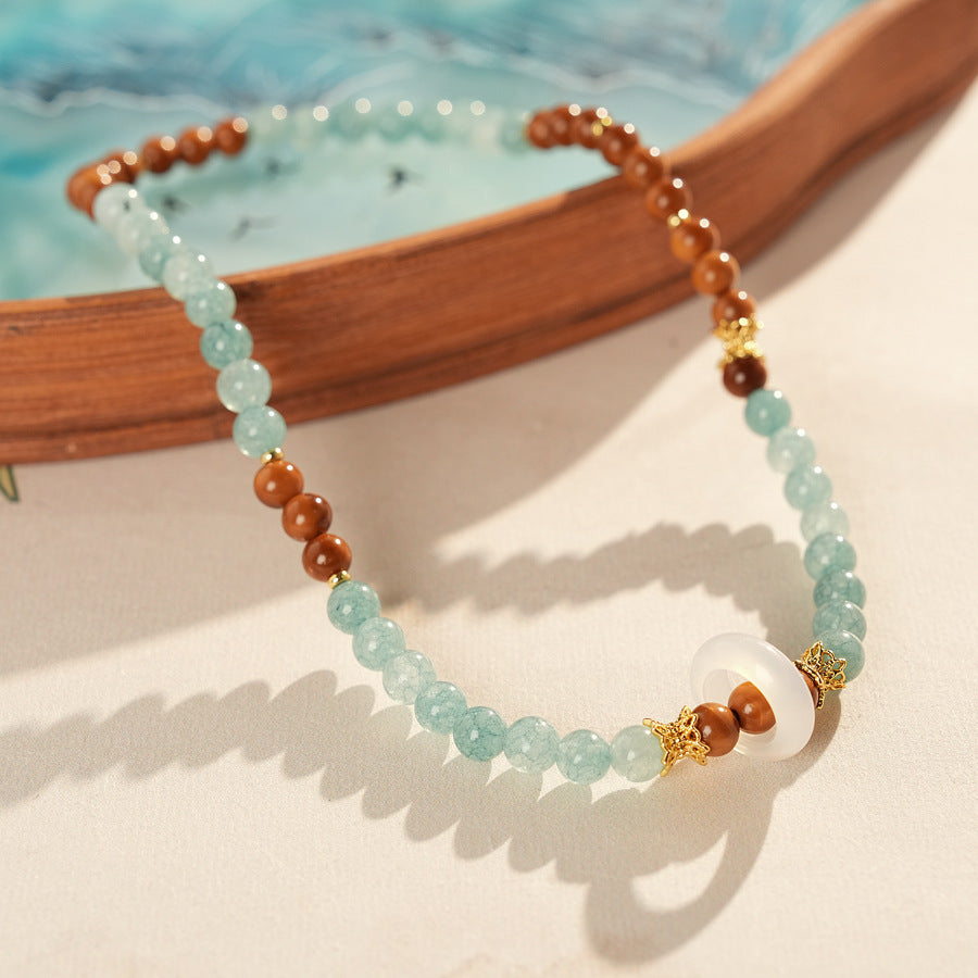A double-wrap bracelet of sea blue and brown chalcedony beads, embellished with white rings - Dual-Tone Chalcedony Double-Wrap Bracelet.