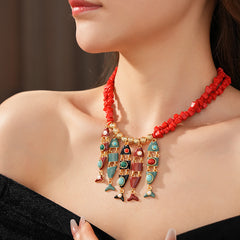 Statement necklace with articulated fishbone fringe, gold beads, and red or black chip strands — Kaleido Fishbone Fringe Necklace.